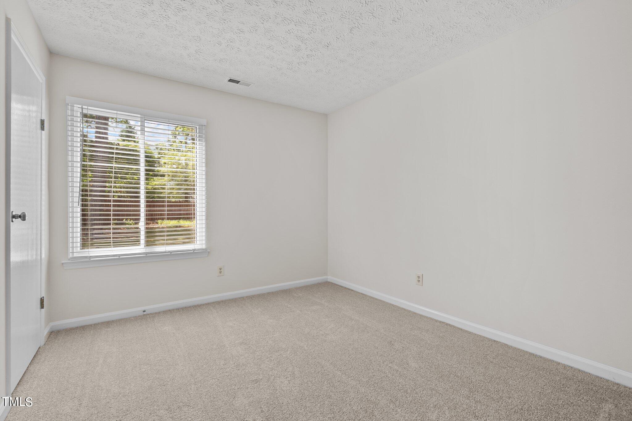 5104 Duckworth Court Raleigh, NC 27616 - Photo 17 of 36 an empty room with a window