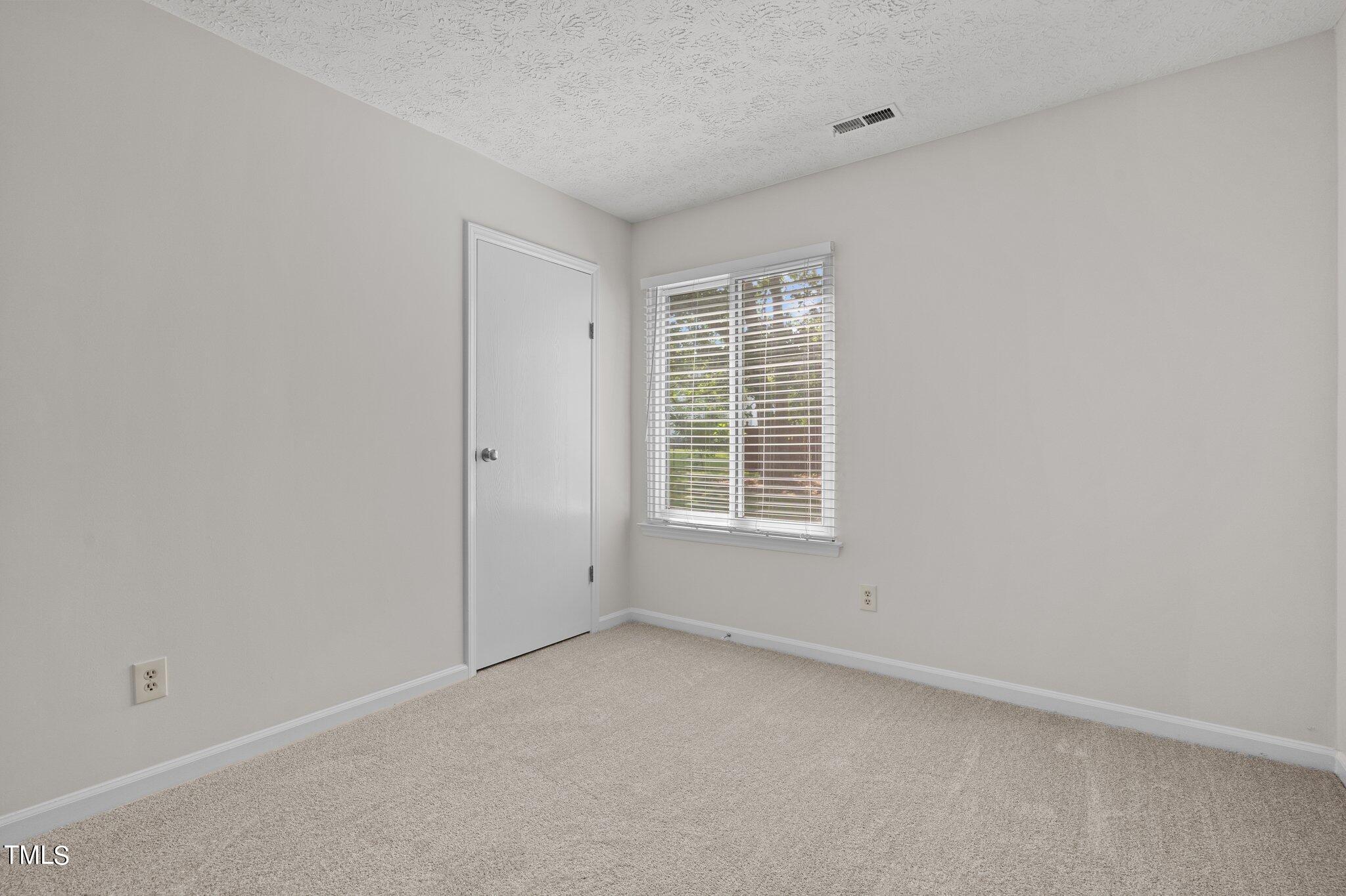 5104 Duckworth Court Raleigh, NC 27616 - Photo 18 of 36 an empty room with a window
