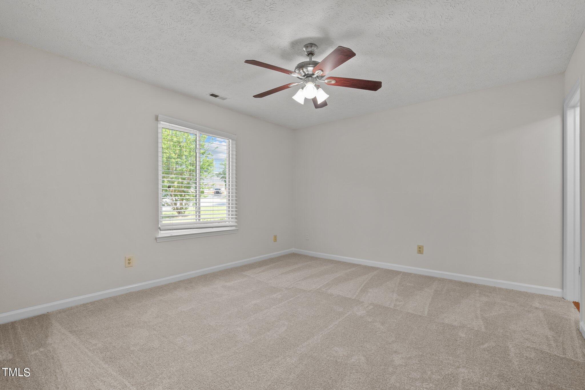 5104 Duckworth Court Raleigh, NC 27616 - Photo 21 of 36 an empty room with windows and fan