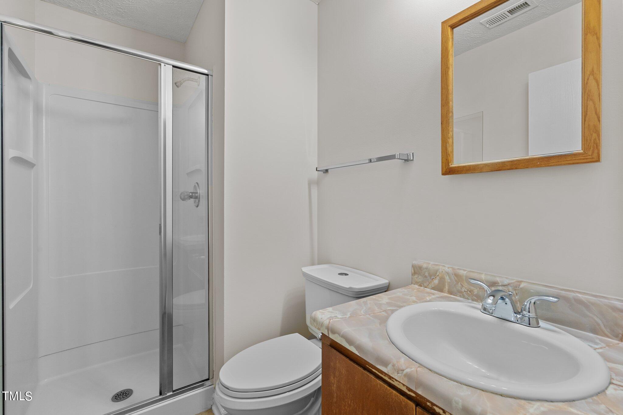 5104 Duckworth Court Raleigh, NC 27616 - Photo 24 of 36 a bathroom with a sink a toilet and shower