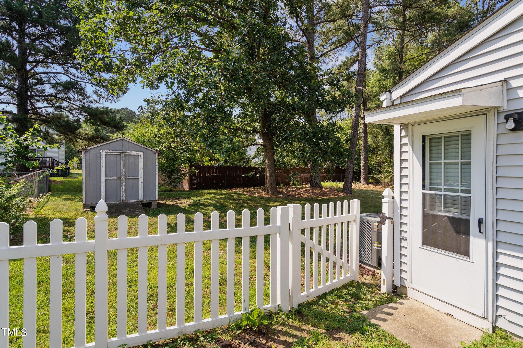 5104 Duckworth Court Raleigh, NC 27616 - Photo 30 of 36 a view of small house with wooden fence