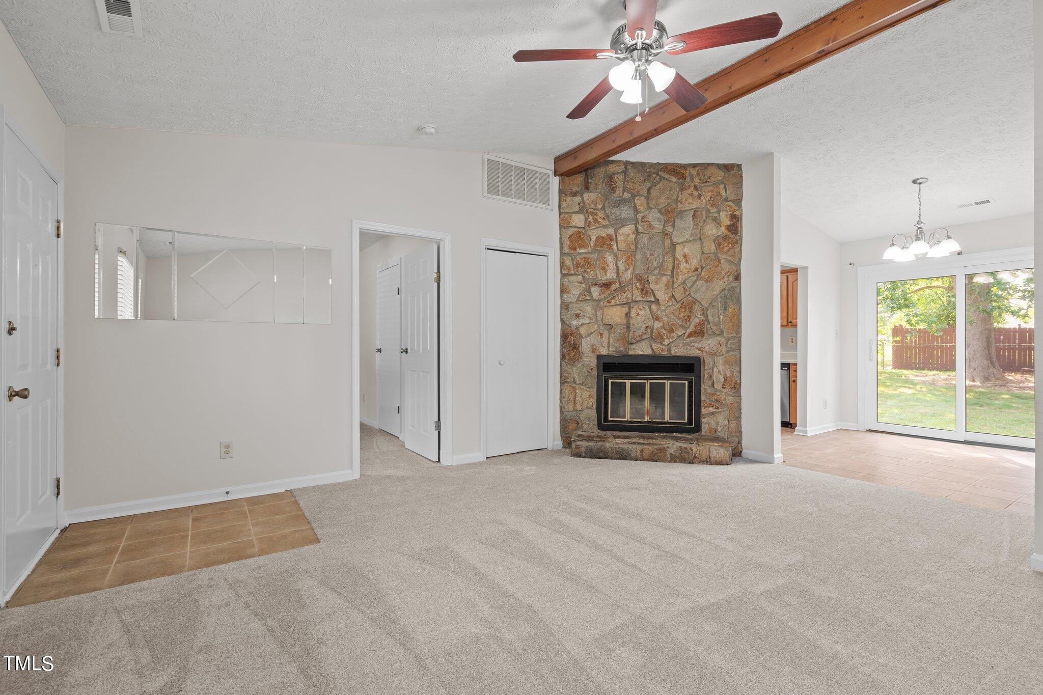 5104 Duckworth Court Raleigh, NC 27616 - Photo 3 of 36 a view of an empty room with a fireplace and a window
