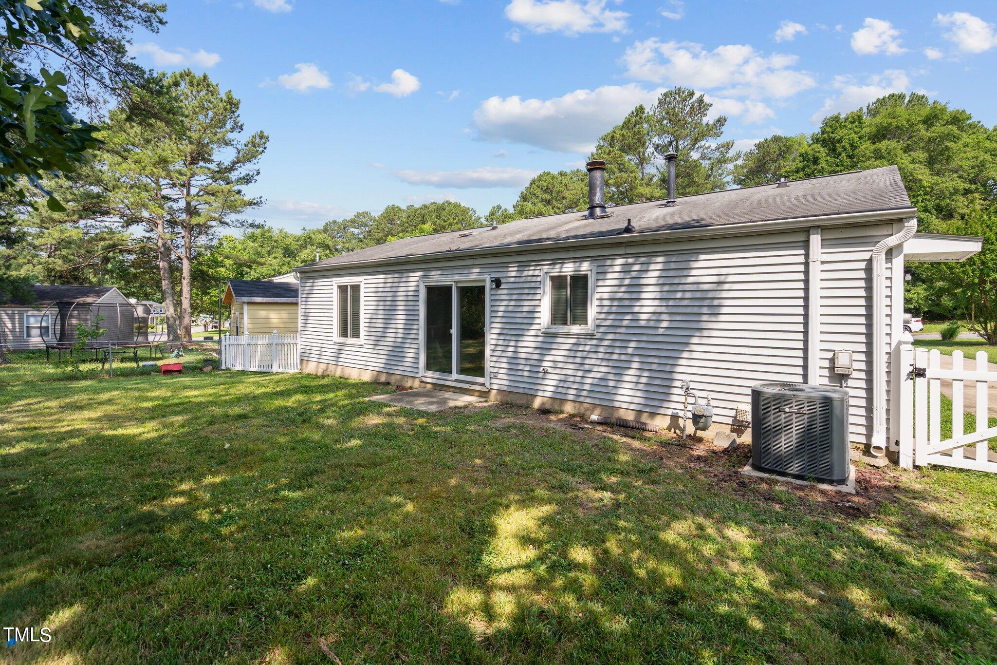 5104 Duckworth Court Raleigh, NC 27616 - Photo 32 of 36 a backyard of a house with table and chairs