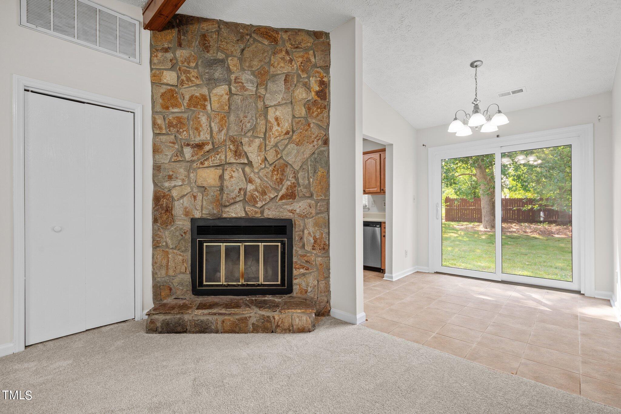 5104 Duckworth Court Raleigh, NC 27616 - Photo 5 of 36 a view of an empty room with a fireplace and a window