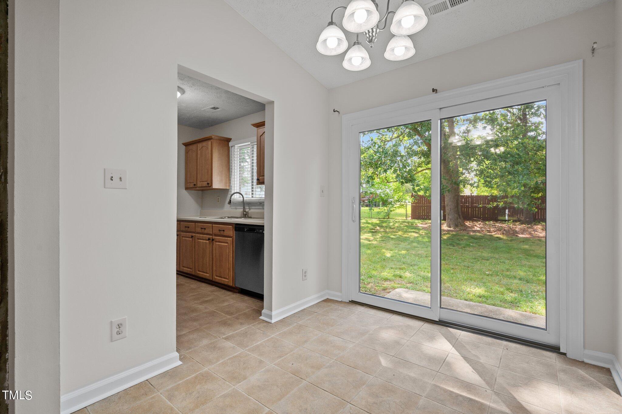 5104 Duckworth Court Raleigh, NC 27616 - Photo 8 of 36 a view of open kitchen with a sink and a large window