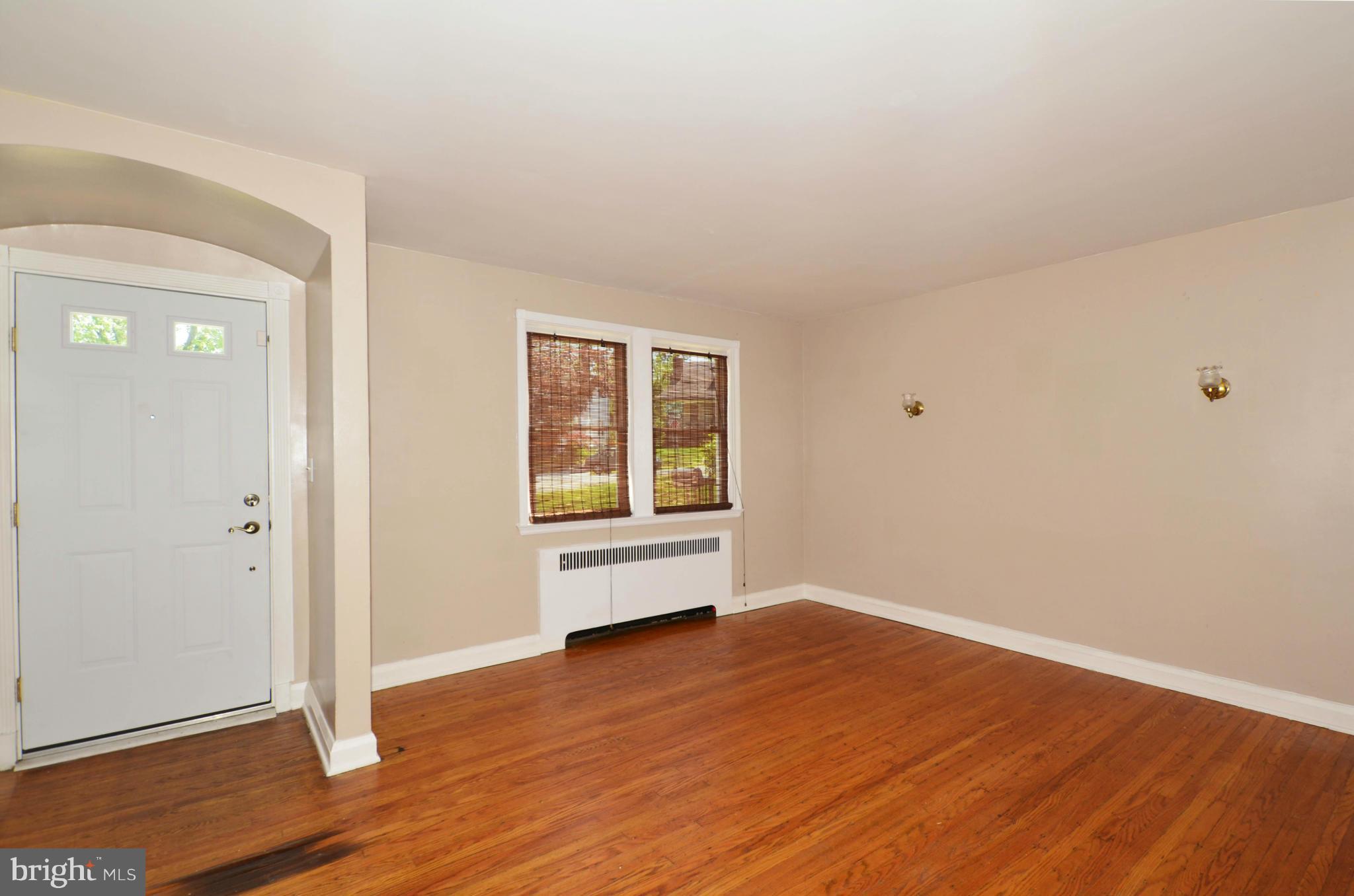 5226 Cromarty Road Baltimore, MD 21229 - Photo 3 of 30 an empty room with wooden floor and windows