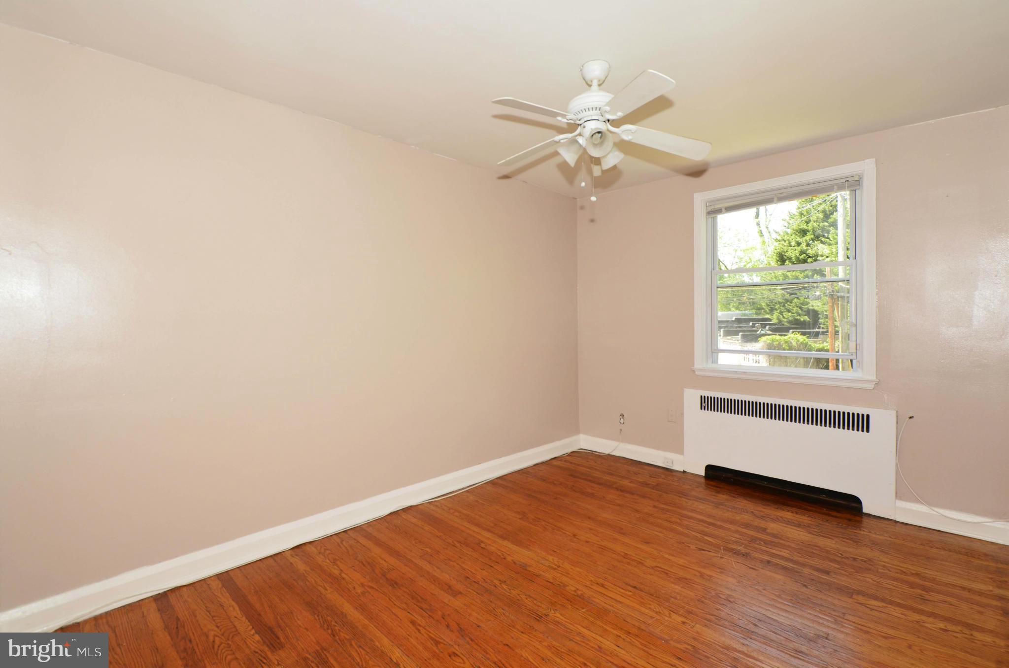 5226 Cromarty Road Baltimore, MD 21229 - Photo 23 of 30 an empty room with wooden floor fan and windows