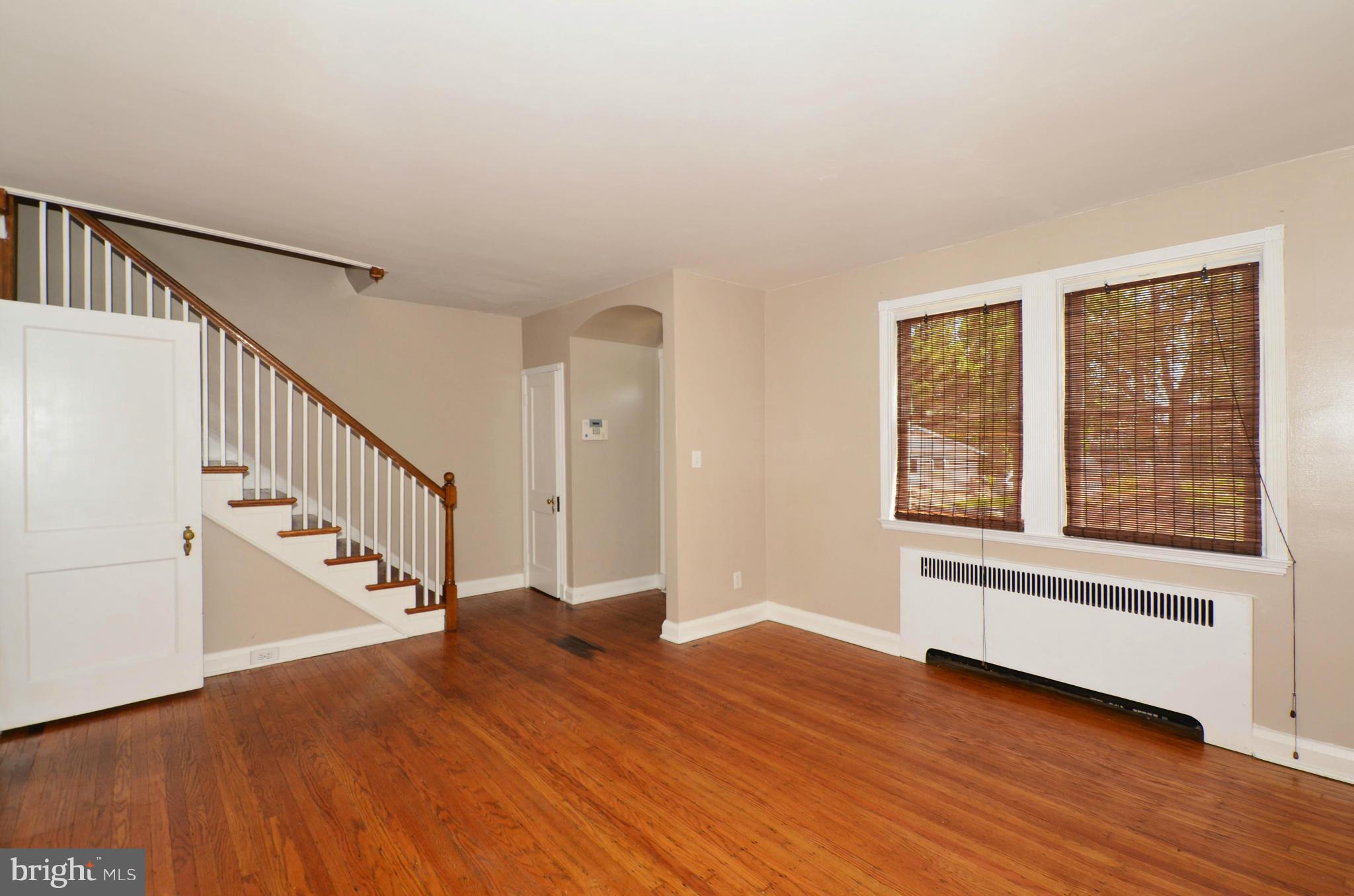 5226 Cromarty Road Baltimore, MD 21229 - Photo 6 of 30 a view of an entryway with wooden floor and stairs