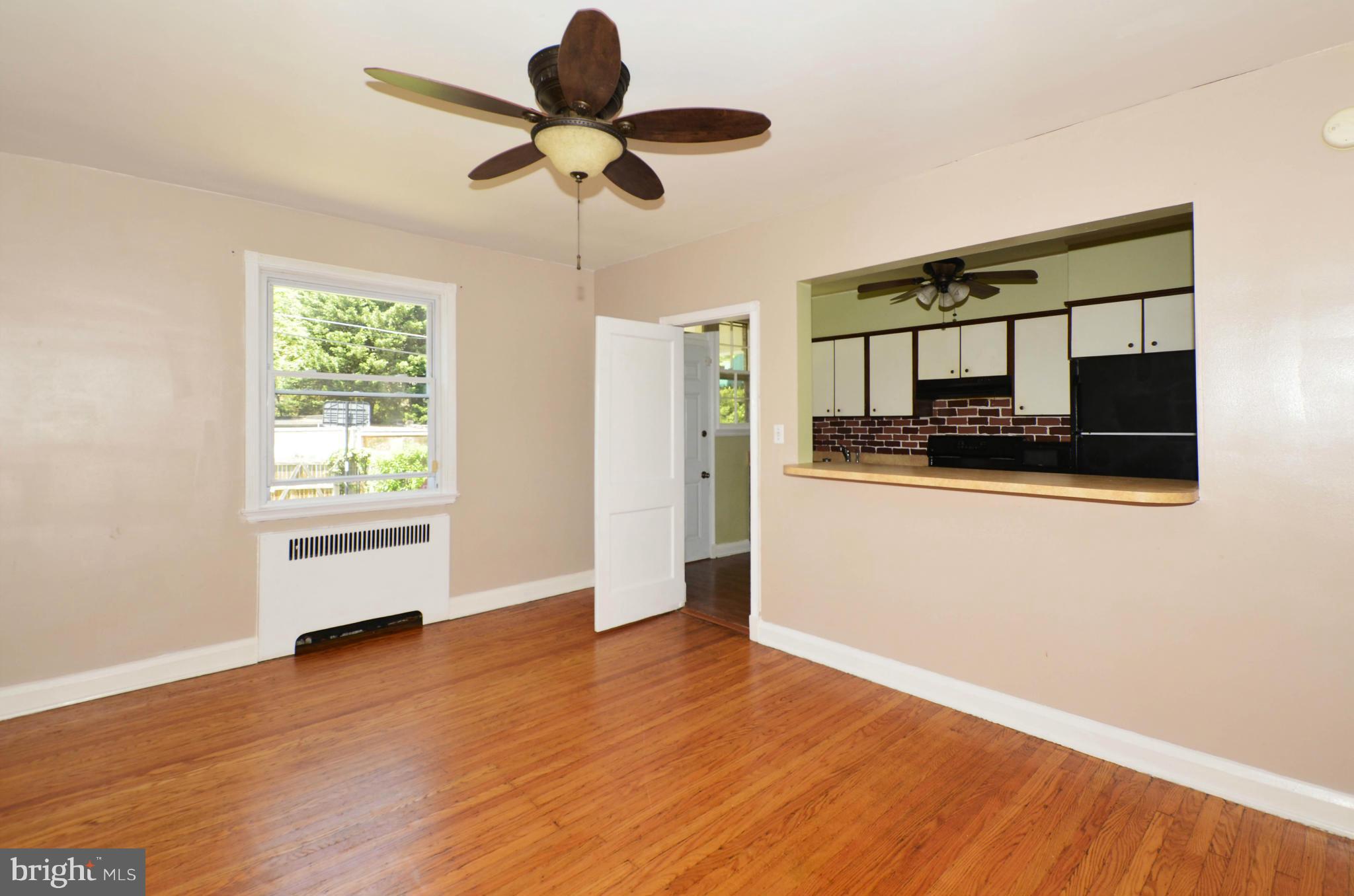 5226 Cromarty Road Baltimore, MD 21229 - Photo 7 of 30 a view of a room with wooden floor and a ceiling fan
