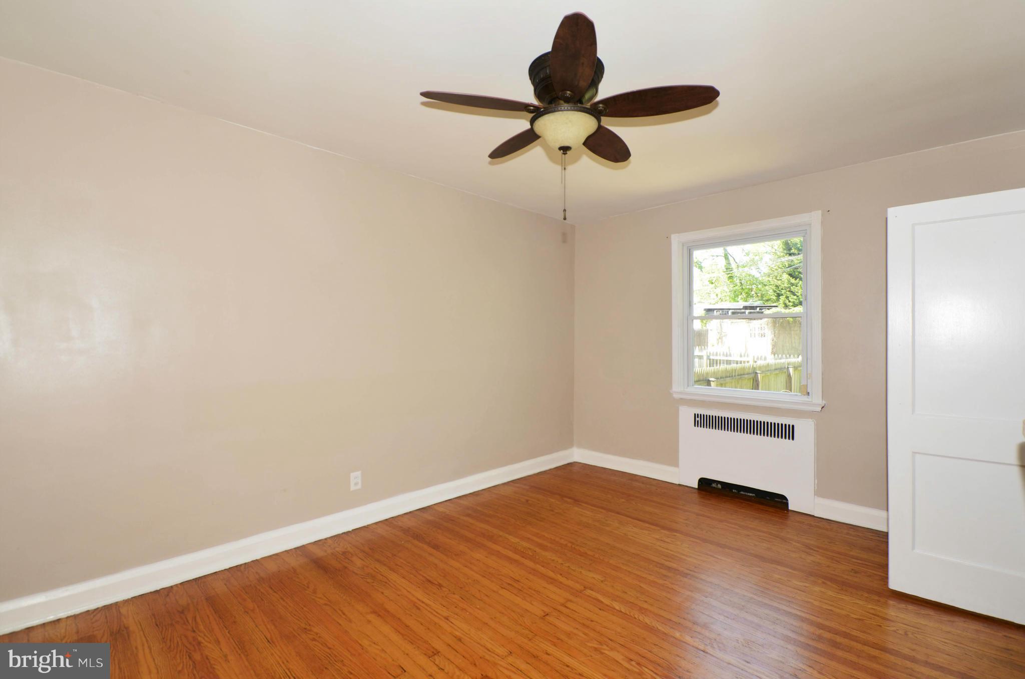 5226 Cromarty Road Baltimore, MD 21229 - Photo 10 of 30 a view of empty room with wooden floor and window