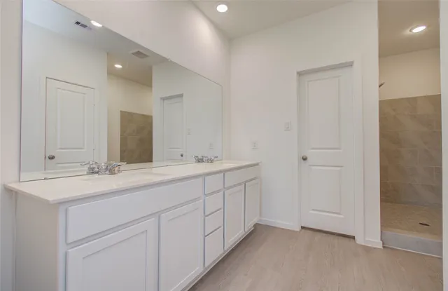 a bathroom with 2 sink and a mirror