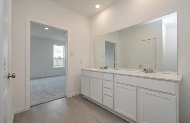 a bathroom with 2 sink and a mirror