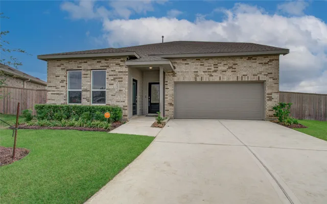 a front view of a house with a garden and plants