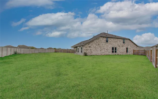 a view of a backyard with brick wall