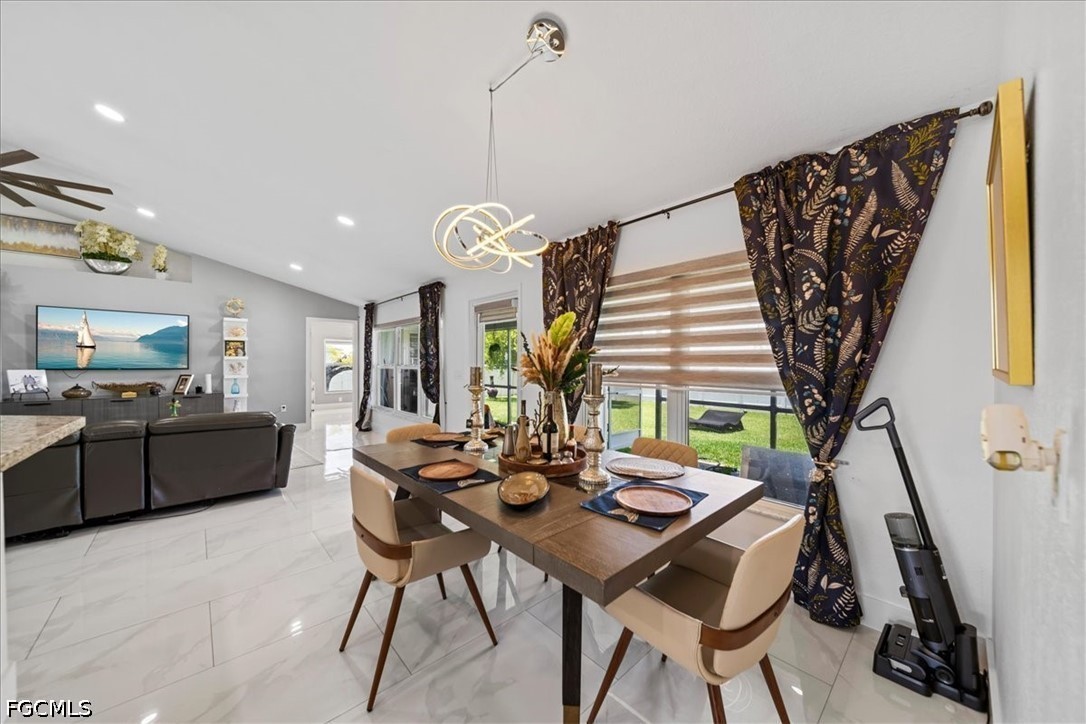 22 Nelson Road South Cape Coral, FL 33991 - Photo 19 of 43 a view of a dining room with furniture and wooden floor