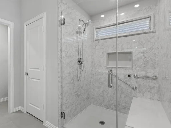 a bathroom with a shower and a tub