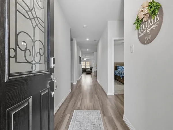 a view of a hallway with wooden floor