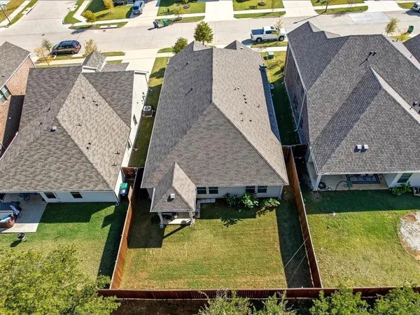 an aerial view of residential houses with outdoor space and swimming pool