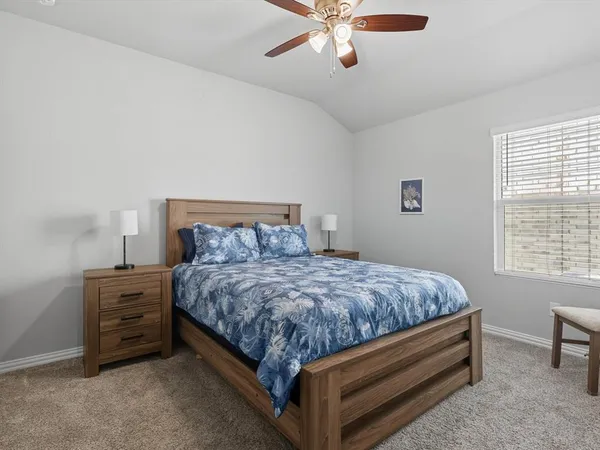 a bed sitting in a bedroom next to a window