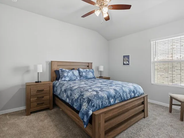 a bed sitting in a bedroom next to a window
