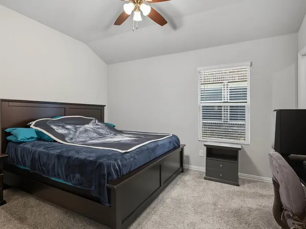 a bedroom with a bed and a television