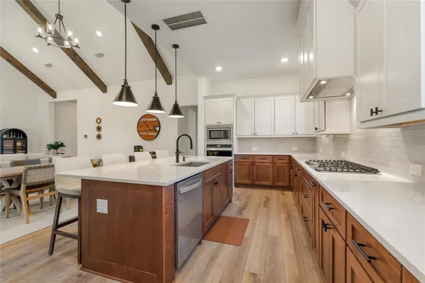 a kitchen with a sink stove and cabinets