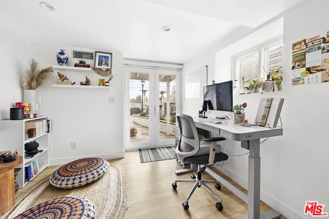 a view of a workspace with furniture and a bedroom