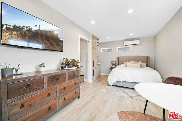 a bedroom with a large bed and a dresser