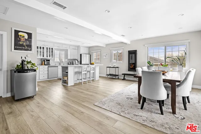 a living room with furniture and a dining table with kitchen view