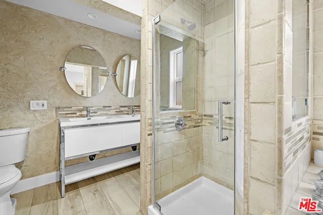 a bathroom with a sink mirror vanity and toilet