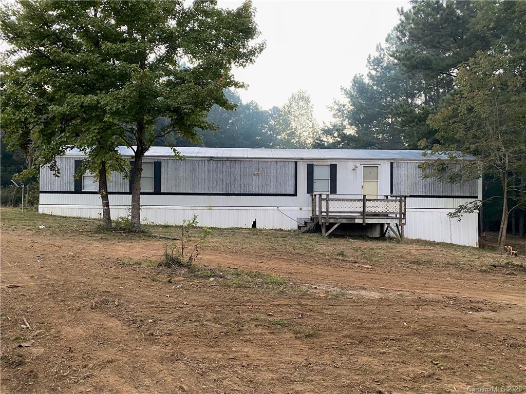 1562 Dunlap Roddey Road Rock Hill, SC 29730 - Photo 1 of 14 a backyard of a house with wooden floor and large trees