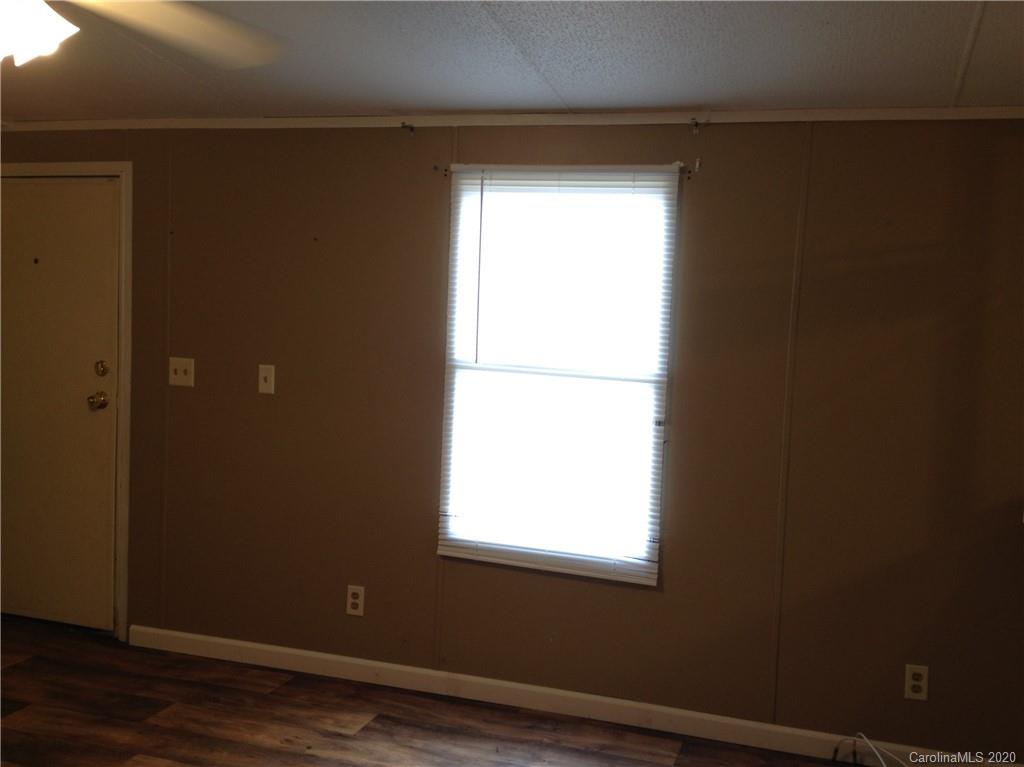 1562 Dunlap Roddey Road Rock Hill, SC 29730 - Photo 7 of 14 a view of an empty room with wooden floor and a window