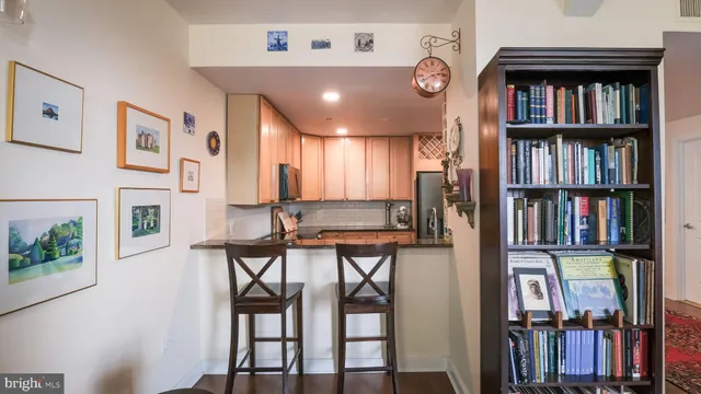 a view of a livingroom with furniture and a bookshelf