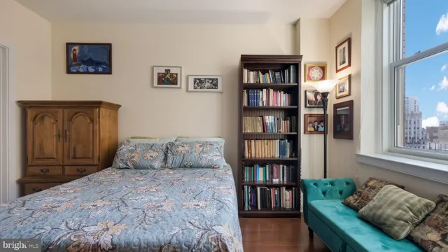 a bedroom with a bed and a book shelf