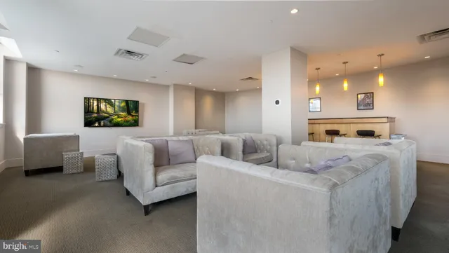 a view of a dining room with furniture and a chandelier fan