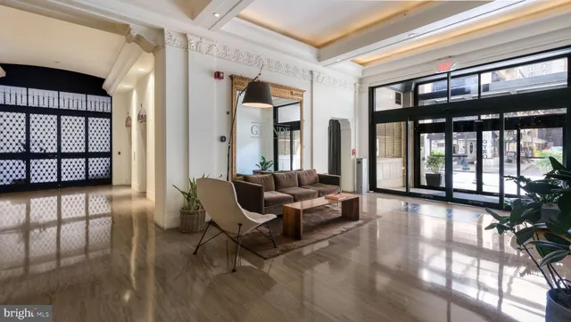 a living room with furniture and floor to ceiling windows