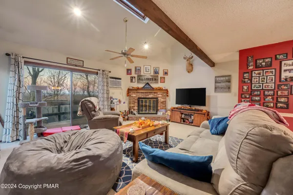 a view of a livingroom with furniture and a flat screen tv