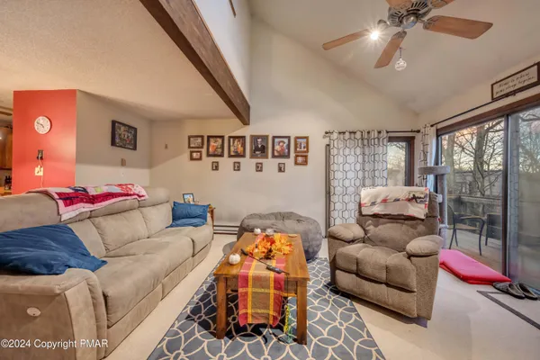 a living room with furniture and a floor to ceiling window
