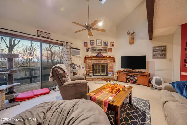 a bedroom with a bed a flat screen tv and a couch