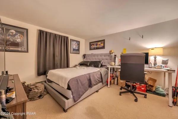a bedroom with a bed and a desk