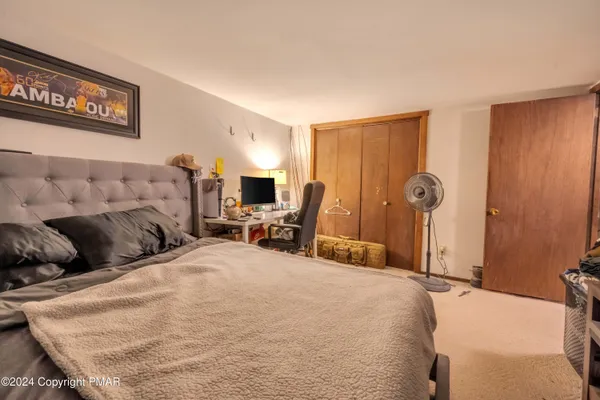 a bed room with a bed and a chair