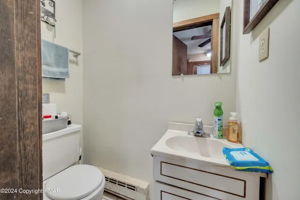 a bathroom with a sink a toilet and a mirror