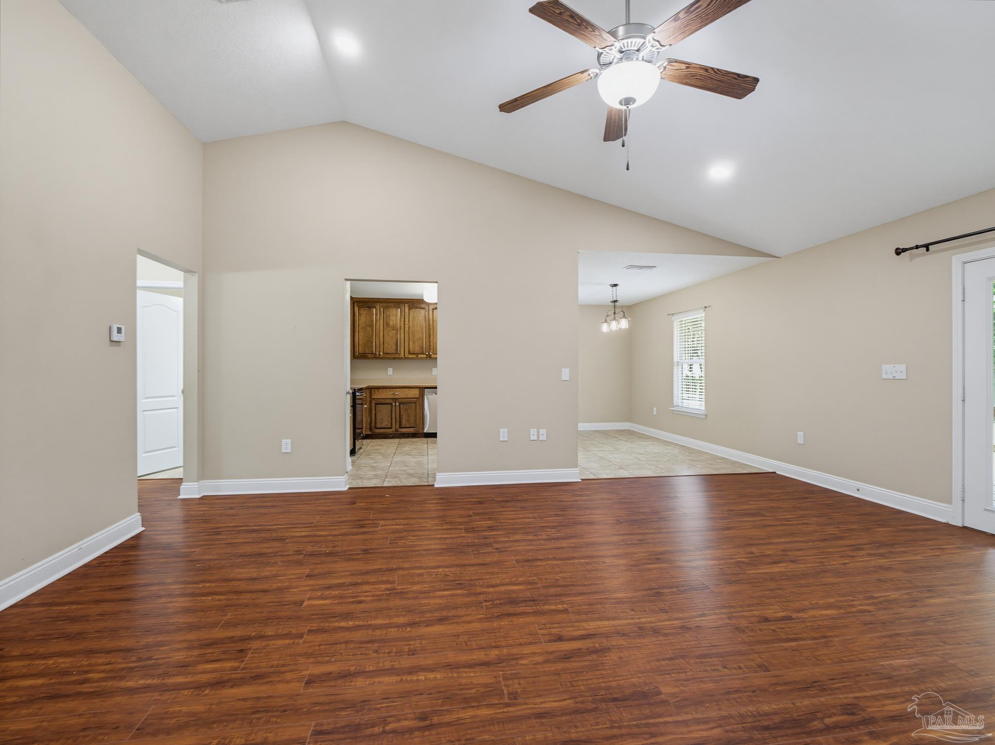 5567 Jones Street Milton, FL 32570 - Photo 9 of 48 a view of an empty room with window and wooden floor