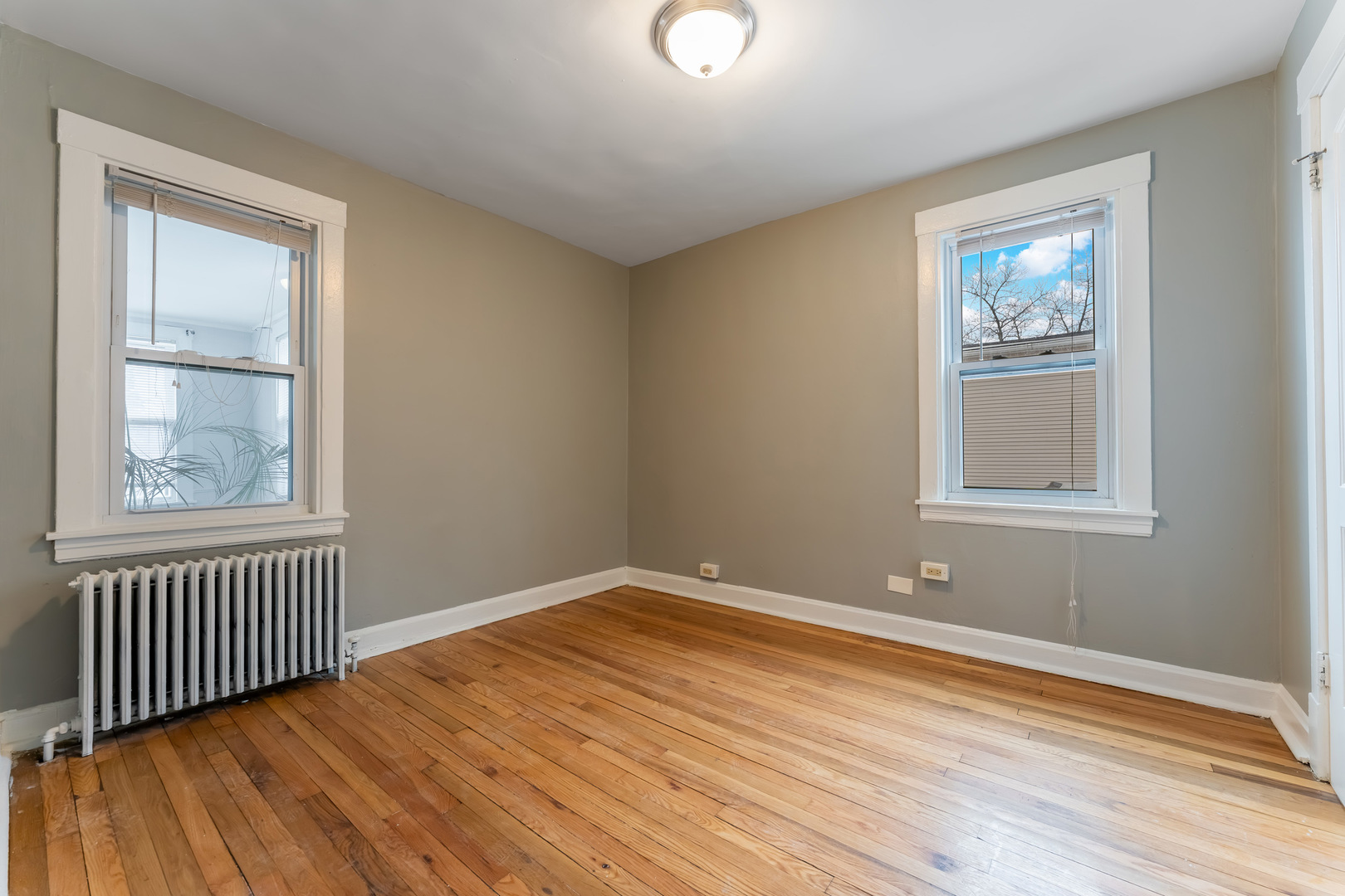 3908 West Montrose Avenue, Unit 2R Chicago, IL 60618 - Photo 6 of 10 a view of an empty room with wooden floor and a window