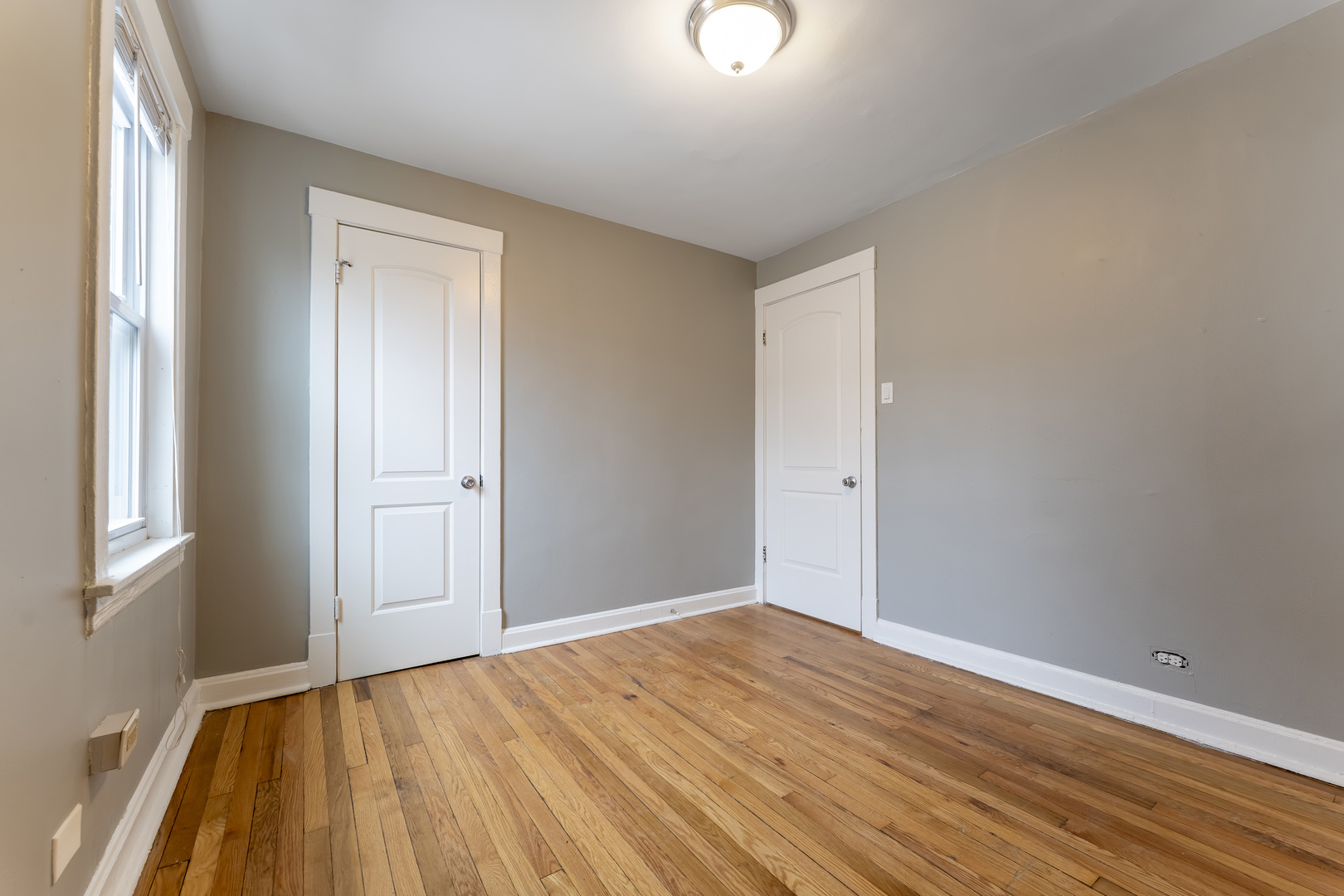 3908 West Montrose Avenue, Unit 2R Chicago, IL 60618 - Photo 7 of 10 a view of empty room with wooden floor