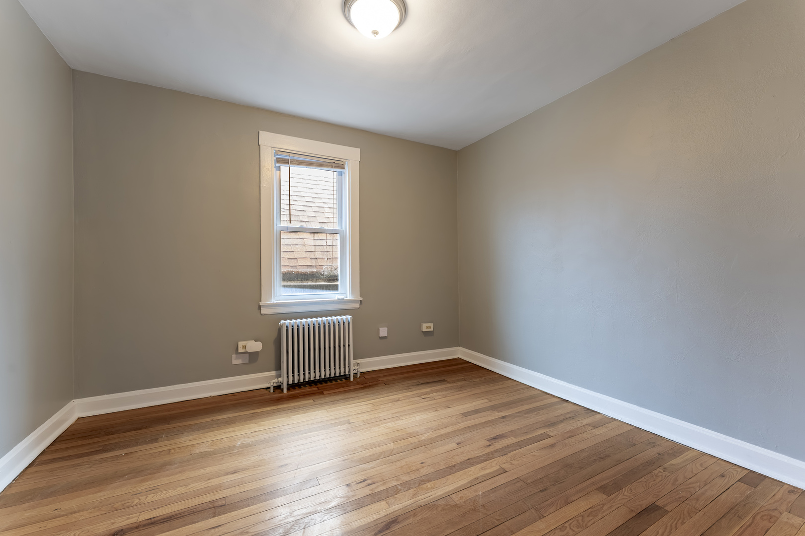 3908 West Montrose Avenue, Unit 2R Chicago, IL 60618 - Photo 9 of 10 a view of an empty room with wooden floor and a window