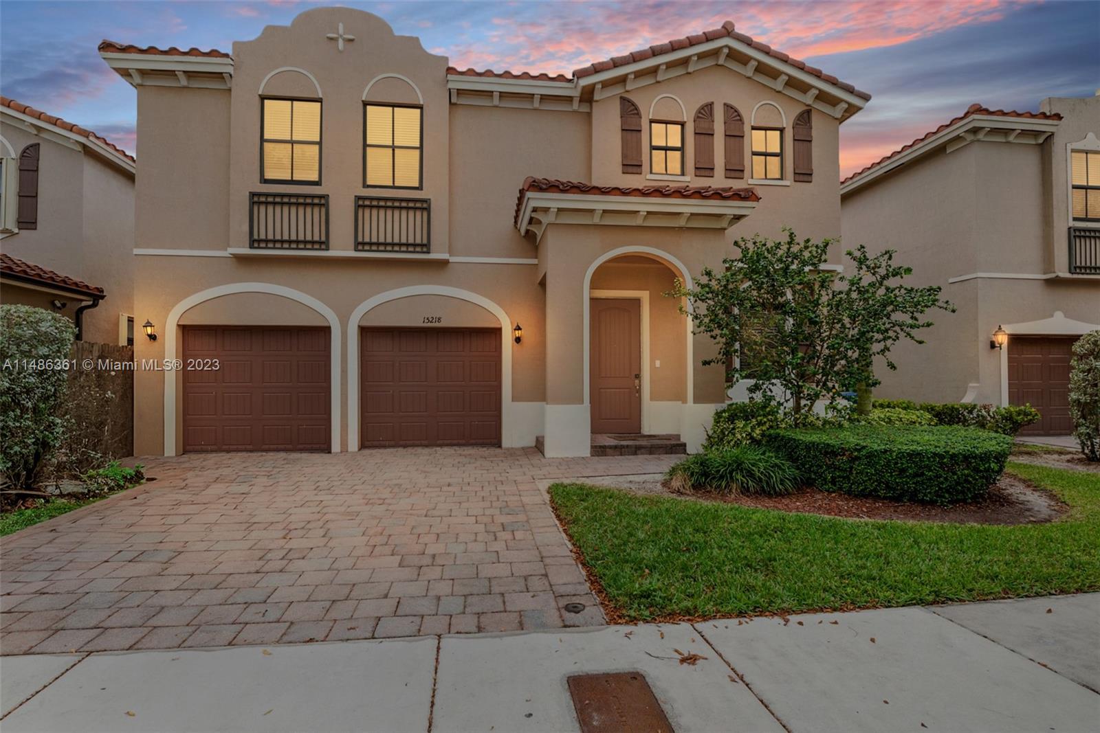 15218 Southwest 173rd Lane Miami, FL 33187 - Photo 13 of 14 a front view of a house with a garden