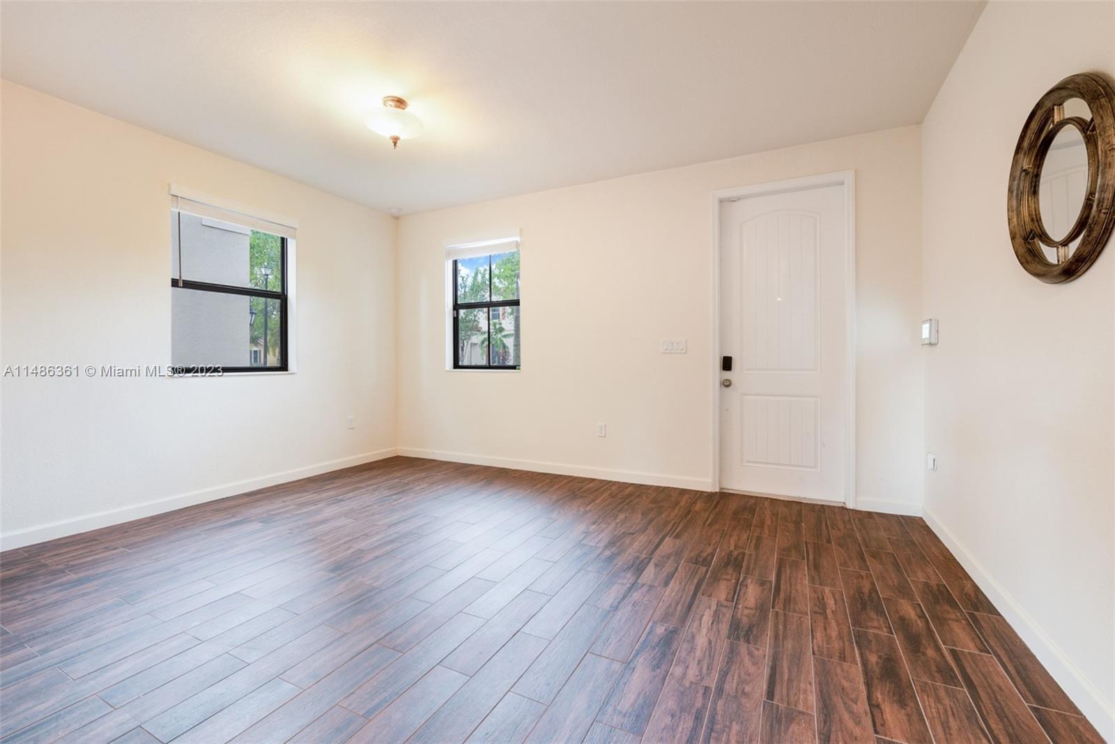 15218 Southwest 173rd Lane Miami, FL 33187 - Photo 8 of 14 a view of a room with wooden floor and window