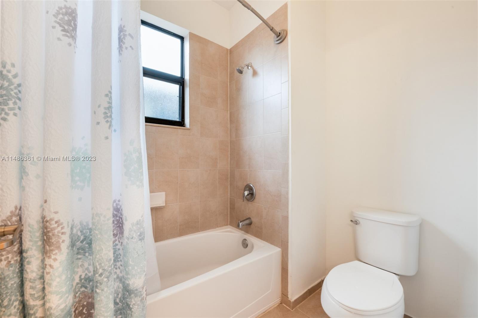 15218 Southwest 173rd Lane Miami, FL 33187 - Photo 9 of 14 a white toilet sitting next to a bathtub