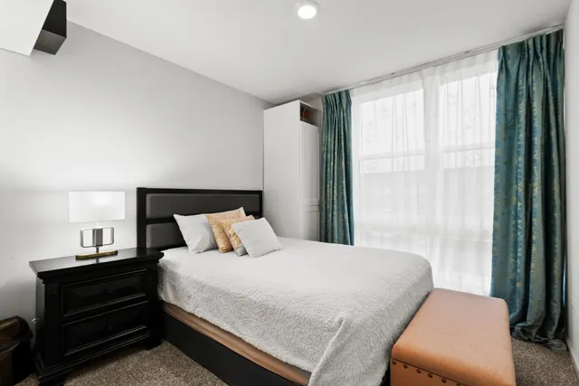 a bedroom with a bed and window